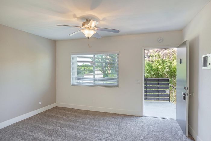 Living room with private balcony access and neutral carpet at Elan - beachlofts del mar
