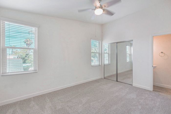 Spacious room featuring mirrored closet doors and fan at Elan - beachhouse del mar