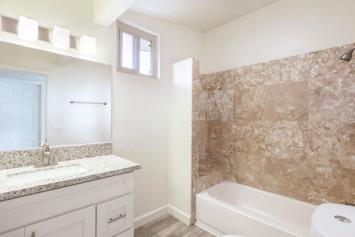 Clean bathroom featuring a white vanity and large mirror at Elan - beachhouse del mar