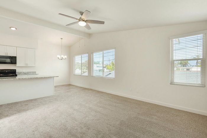 Sunlit living space with neutral carpet and large windows at Elan - beachhouse del mar