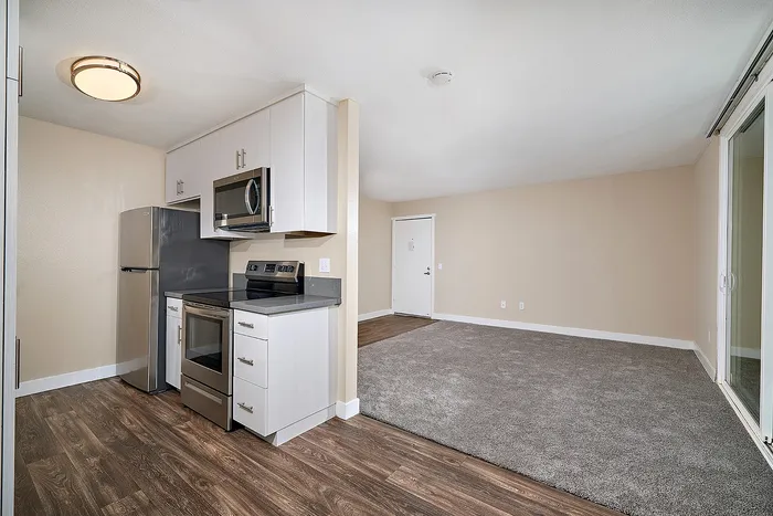 kitchen with wood-like flooring and living room with carpet at Creekwood Villas