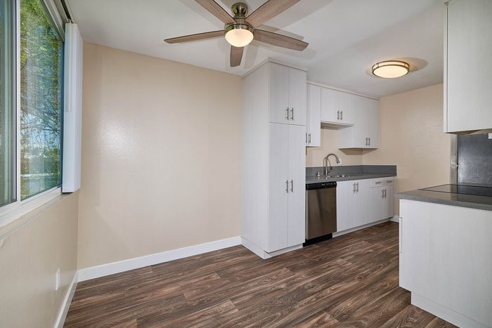 dining area and kitchen with wood-like flooring at Creekwood Villas