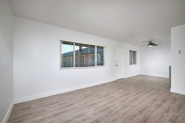 living room and dining area with wood-like flooring at Elivia