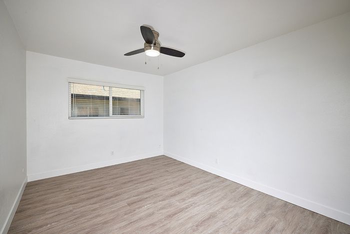 bedroom with wood-like flooring at Elivia