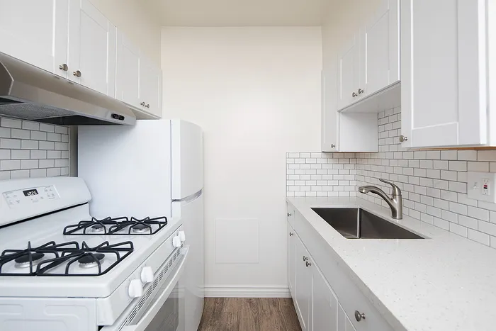 galley style kitchen with white appliances at Avaz Pacific Beach