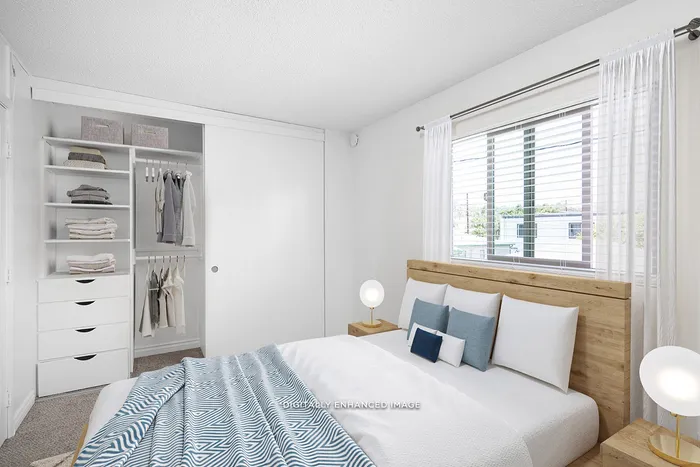 virtually staged bedroom with built-in storage in a large closet