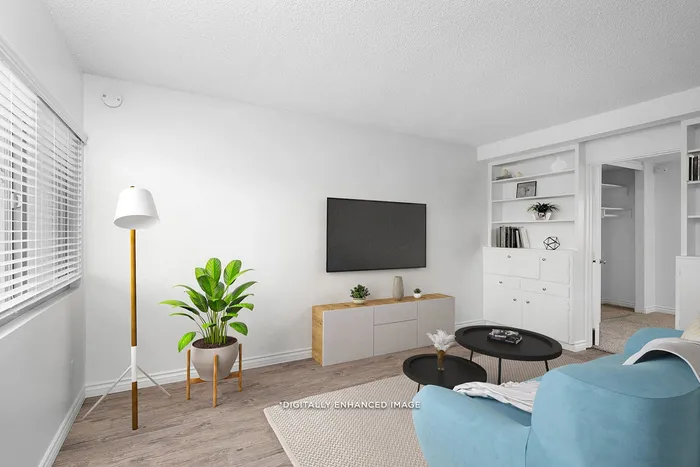 Virtually staged living room with window coverings, wood-style flooring, and built-in storage