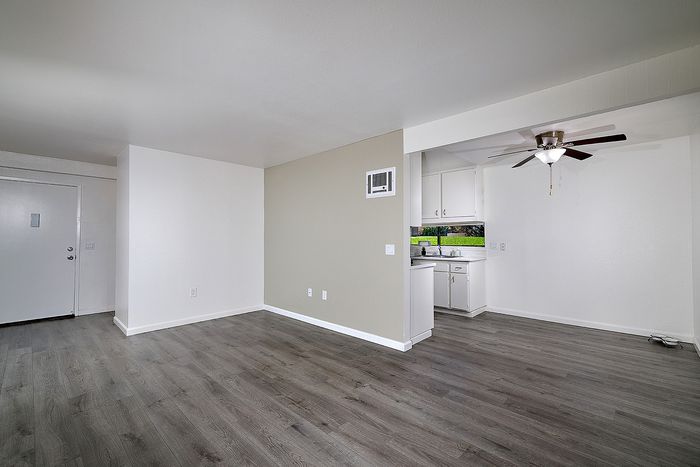 Living room and dining with wood-like flooring at Canyon Park