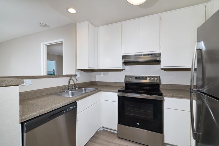 Kitchen with dishwasher, oven, and fridge