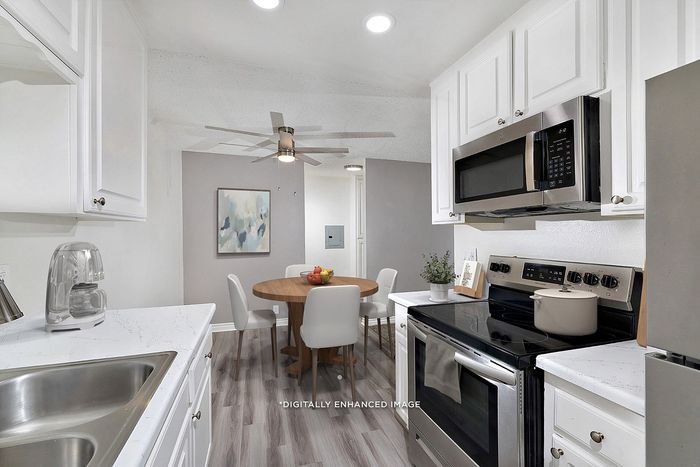 Virtually staged two bedroom at Pine Vista showing a dining room and kitchen