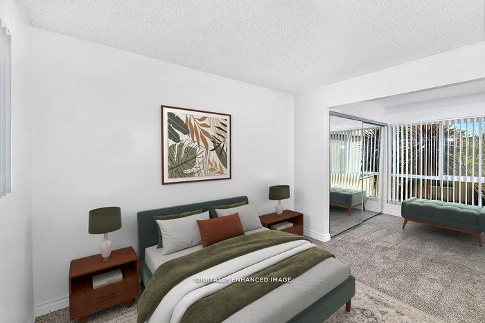 Virtually staged primary bedroom at Pine Vista with a bed, nightstands and bench