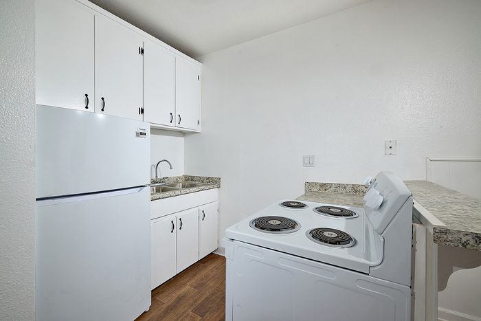Kitchen with refrigerator, sink, and stove