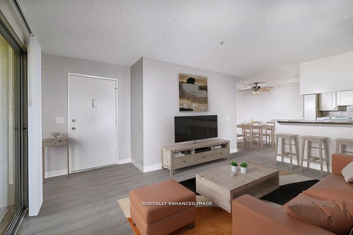 Virtually staged living room with sofa, coffee table, tv, breakfast stools, patio, wooden floors, artwork, dining table, plants, and ceiling fan.