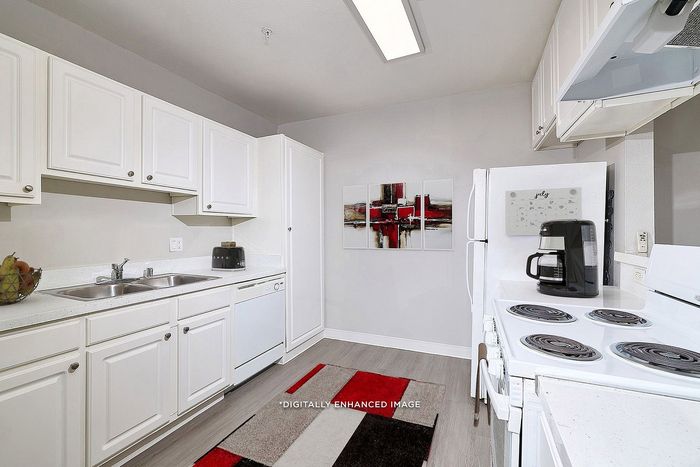 Virtually staged kitchen with red, black, and white mat and artwork, fridge, cupboard, coffee maker, sink, and oven.