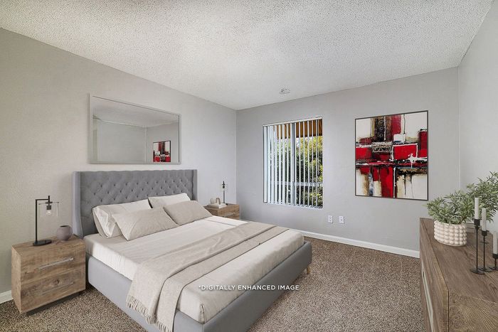 Virtually staged bedroom with bed, side tables, window, artwork, plants, candles, and dresser.
