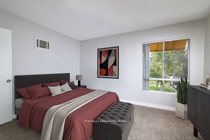 Virtually staged bedroom with bed, lamp, plant, dresser, window, carpet, and artwork.