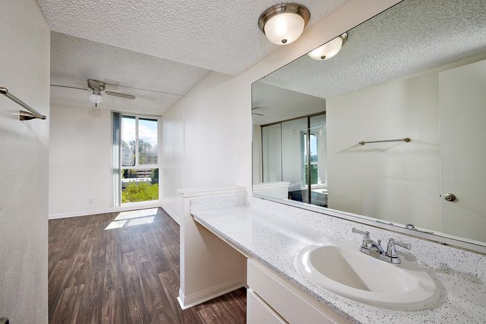 bathroom with large vanity and wood-like flooring at mellmanor