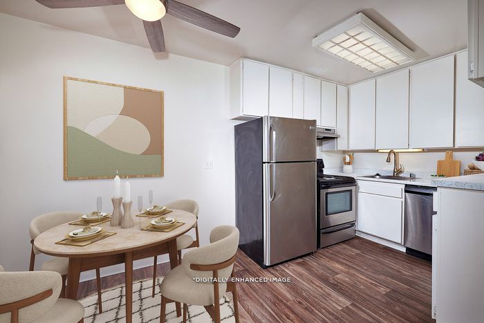 Virtually Staged Image - Large kitchen with stainless steel appliances and dining area