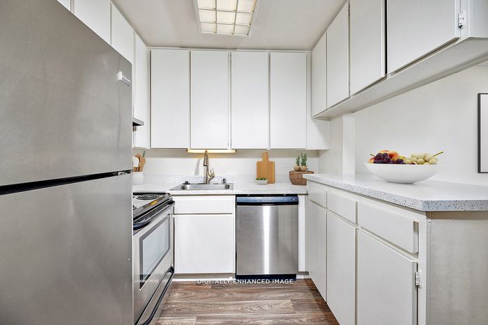 Virtually Staged Image - Stainless Steel Appliances in an updated kitchen with vinyl plank flooring
