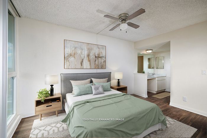 Virtually Staged Image - Bedroom with plush carpeting and ceiling fan leading into the ensuite bathroom