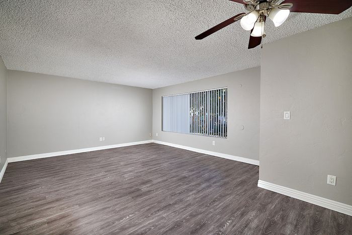 living room with ceiling fan and wood-like flooring