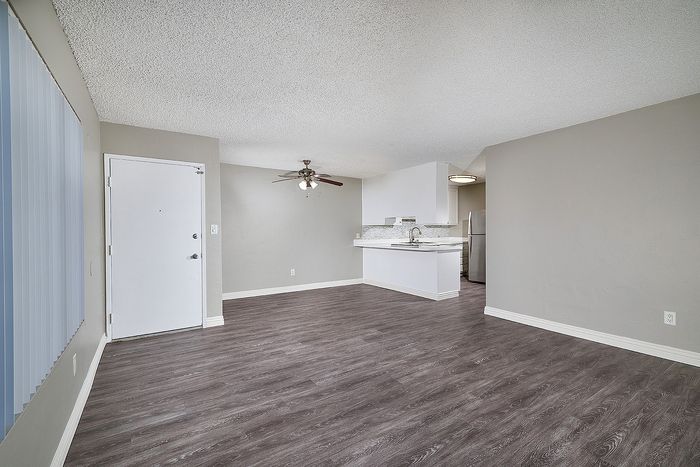 living room with ceiling fan and wood-like flooring