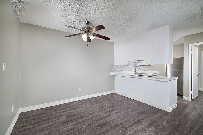 dining area with ceiling fan and wood like flooring