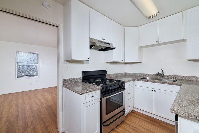 Kitchen with oven, sink, and stove