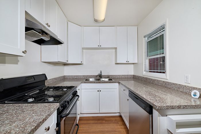 Kitchen with oven, sink, and stove