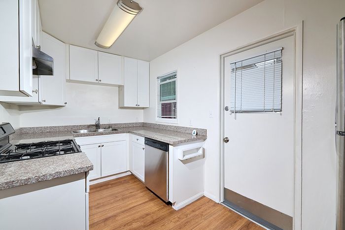 Kitchen with oven, sink, and stove