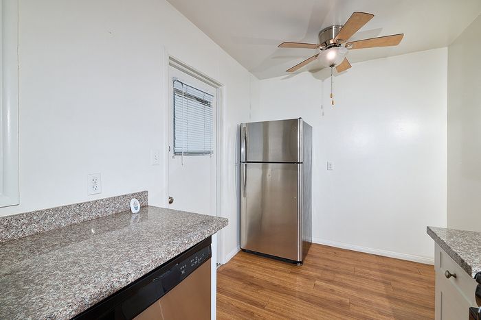 Kitchen with fridge, fan, and countertops