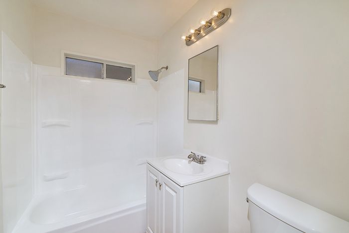 Bathroom with shower, tub, sink, and mirror