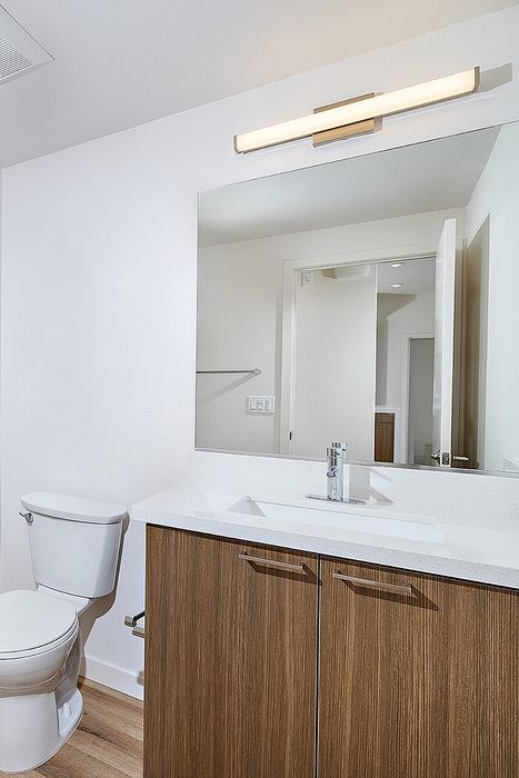 bathroom with mirror, sink, and toilet