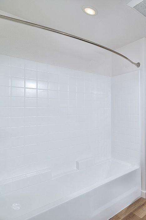 bathtub with shower railing