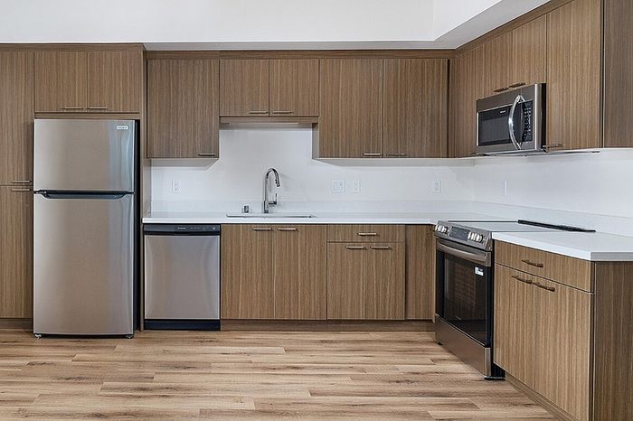kitchen with fridge, dishwasher, sink, microwave, and oven