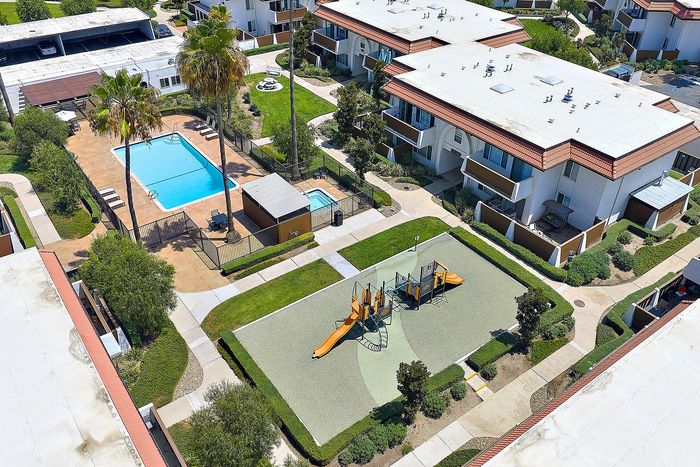 drone footage of the community with pool and playground