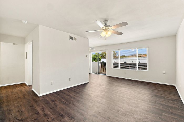 unit living room with wooden floor and ceiling fan
