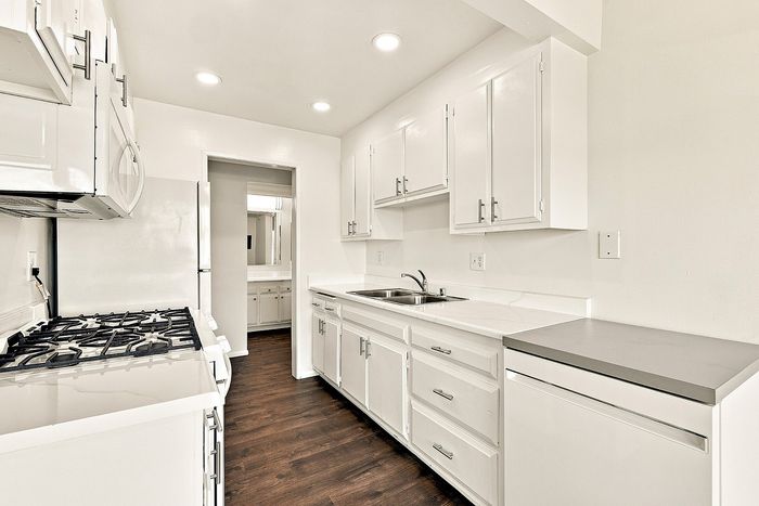 unit kitchen with sink, oven, and fridge