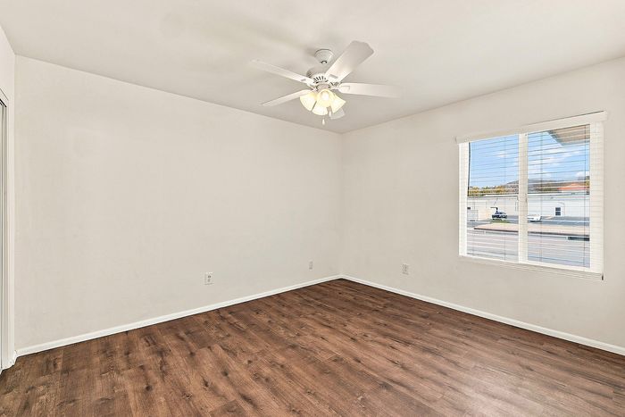 bedroom with wooden floor and ceiling fan