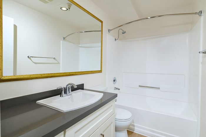 apartment bathroom with sink, toilet, and bathtub