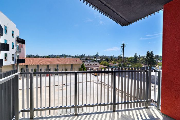 Balcony view of the surrounding La Mesa neighborhood and courtyard area from a textur apartment home.
