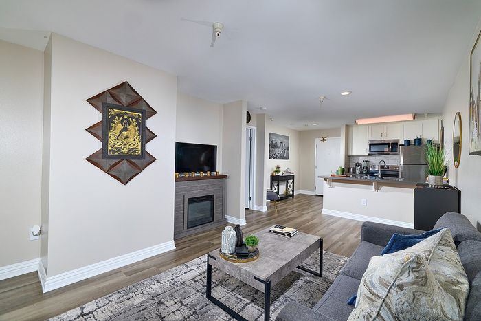 Open floor plan living area connecting to the kitchen at The Warwick Apartment Homes.