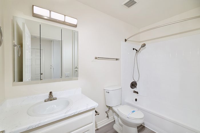 Bathroom at Pine Vista with white cabinets and silver fixtures