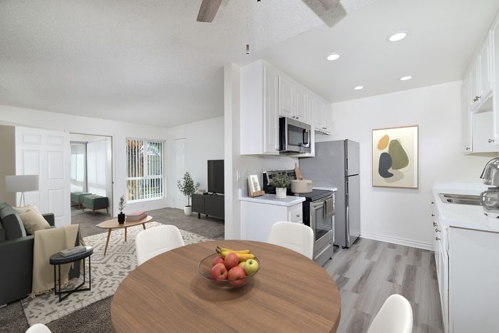 Virtually staged two bedroom at Pine Vista showing a dining room, kitchen and living room