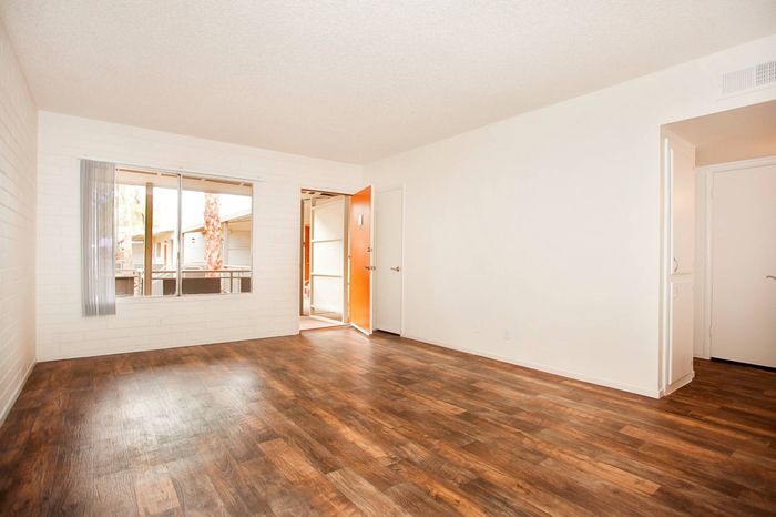 front door and living room with vinyl wood like flooring at Solaris on University