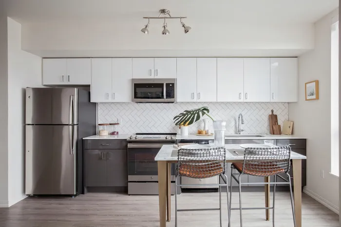 Kitchen with quartz countertops and stainless steel appliances and dining area