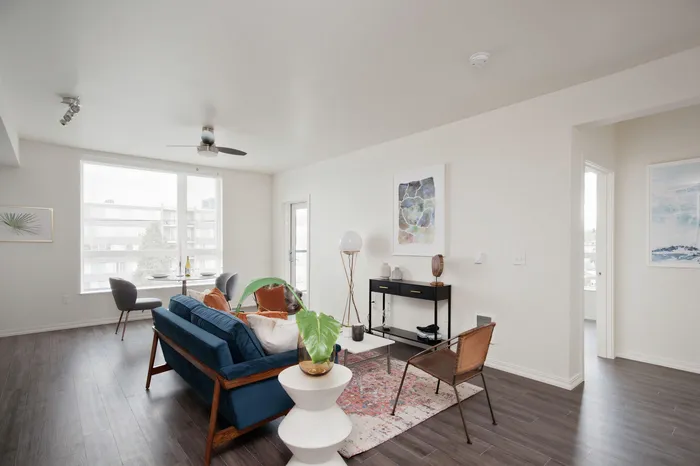 Living room with ample natural light and luxury wood-inspired flooring