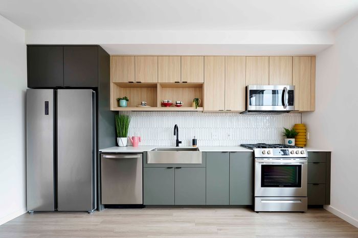 2 BR Apartments in Woodstock, Portland, OR- NOVUS - Open Kitchen With Stainless Steel Appliances, Built-In Microwave, Wood-Inspired Cabinets, And Luxury Vinyl Plank Flooring.