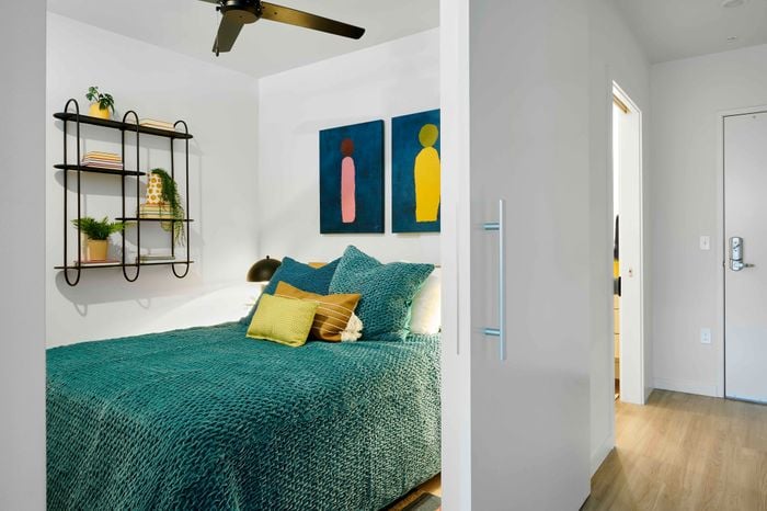 3 BR Apartments in Woodstock, Portland, OR - NOVUS - Bedroom With Sliding Door, Ceiling Fan, And Luxury Vinyl Plank Flooring.