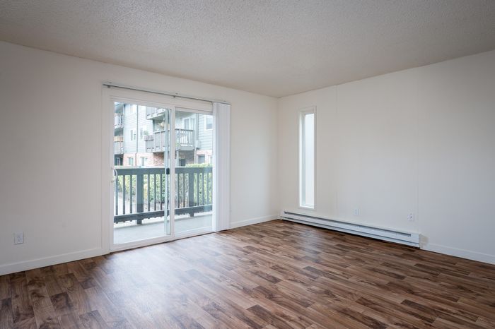 living space with vinyl plank flooring with sliding door out to patio